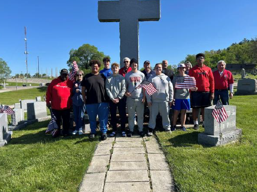 Flag placement at Sacred Heart Cemetery